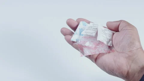 Hand Holds Silica Gel Packets Stock Footage 248685979