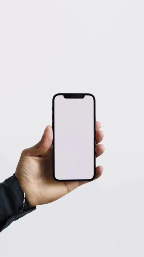 Hand holds smartphone with blank white screen for mockup Video stock 331769972
