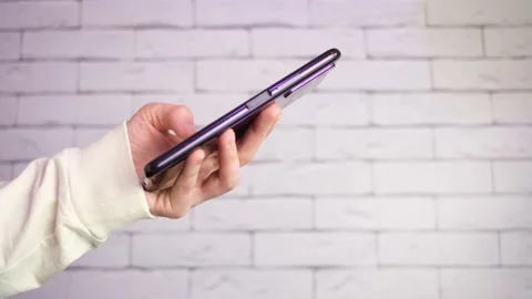 Hand holds smartphone. Stock Footage 151512137