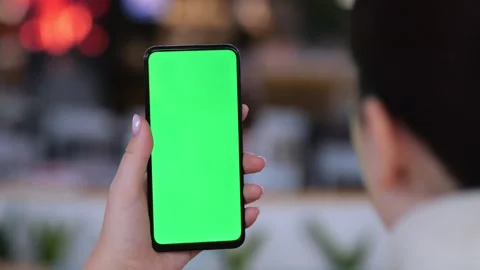 Hand holds smartphone with green screen Stock Footage 346155629