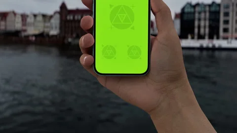 Hand holds smartphone by the riverside Stock Footage 294038385
