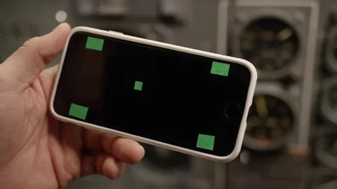 Hand holds smartphone with tracking marks; landscape/sideways Stock Footage 82842630