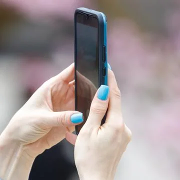 Hand holds smartphone vertically 스톡 사진