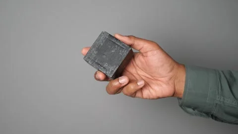 Hand holds square object for demonstration purpose Video stock 325468702