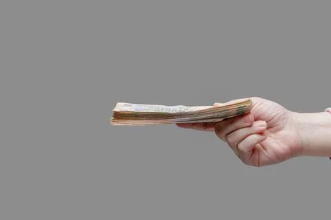 Hand holds a stack of five hundred hryvnia bills, side view Stock Photos