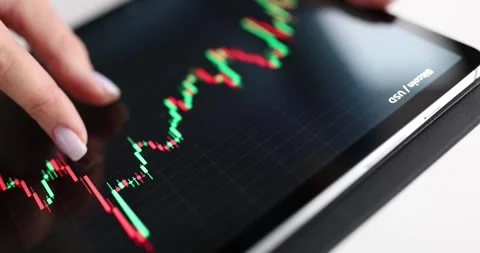 Hand holds tablet with chart of stock markets slow motion 4k movie Stock Footage 252659394