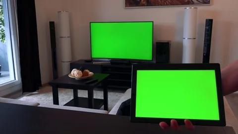 A hand holds a tablet with a green screen - closeup, TV with a green screen in Stock-Footage 71145124