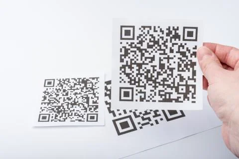 The hand holds the transaction code on a piece of paper. Stock Photos