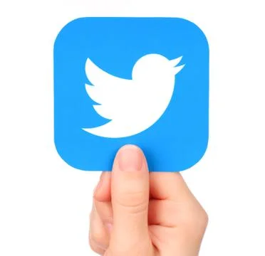 Hand holds Twitter icon printed on paper Stock Photos