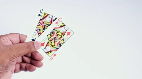 Hand Holds Two Queens Mixed in it Stock Footage 248707159