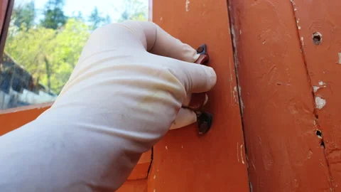 Hand holds window with hand glove during corona a shifty Stock Footage 132495801