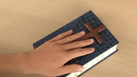 Hand on holy bible with cross as taking pledge loyalty. Burgeoning Stock Footage 274385713