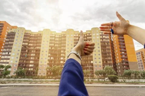Hand with house keys the second hand shows the class, the concept of buying a Stock Photos