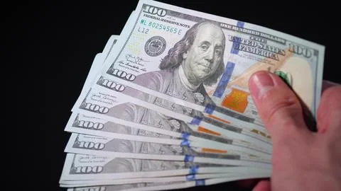 Hand with hundred-dollar bills. Paper money in hand. The businessman holds cash Stock Photos
