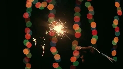 Hand ignites a sparkler from another Stock Footage 81322830