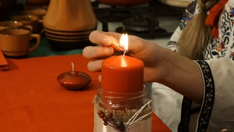 The hand illuminates a red candle Stock Footage 113463127
