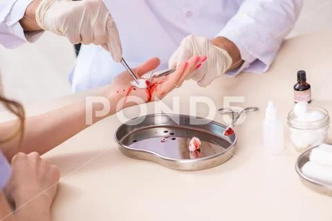 Hand injured woman visiting male doctor Stock Photos