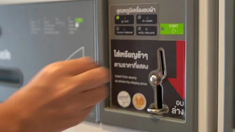 Hand insert coin into automatic machine for operation. Stock Footage 220786966