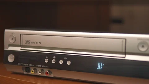 Hand insert old VHS cassette in silver videorecorder Stock Footage 111260606