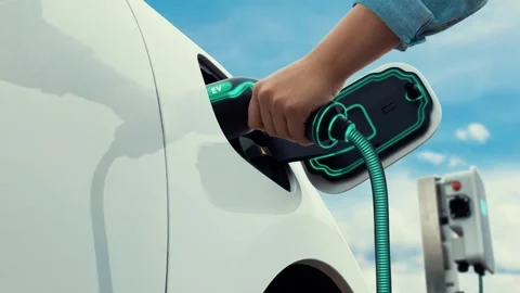 Hand insert smart EV charger to electric car with sky and cloudscape. peruse Stock Footage 264274894