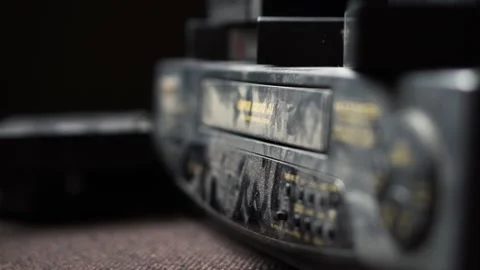 Hand inserted VHS into the VCR Video stock 234407813