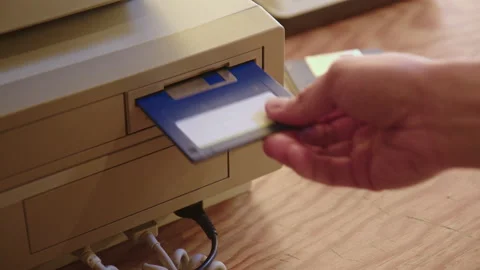 Hand inserting and ejecting Floppy Disk into vintage Commodore Amiga 2000 PC Stock Footage 170898180