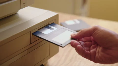 Hand inserting and ejecting Floppy Disk into vintage Commodore Amiga 2000 PC Stock Footage 171215690
