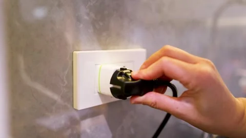Hand Inserting a Black Power Plug into a European Wall Socket 動画素材 332273061