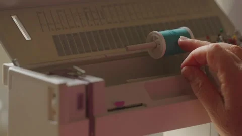 A Hand Inserting Blue Thread Into The Needle On An Electric Sewing Machine Stock Footage 337027517