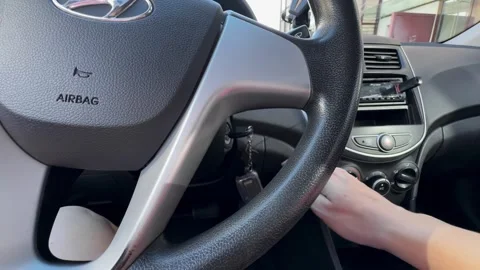 Hand-inserting-car-key-ignition-steering-wheel Video stock 341401631