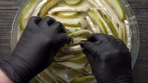 Hand inserting cheese into rolled phyllo dough pie top view Stock Footage 328093243