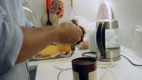 Hand inserting coffee capsule into espresso machine in white kitchen, brewing Stock Footage 323901827