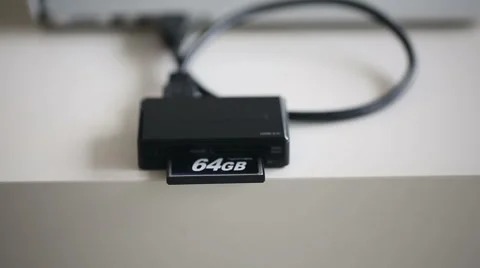 Hand inserting compact flash 64Gb in memory card reader Stock Footage 47745969
