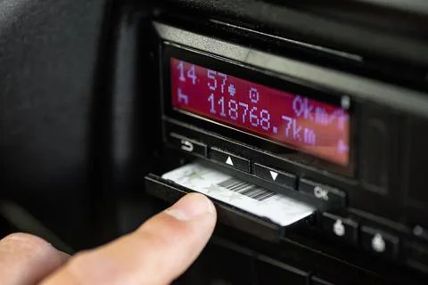 Hand inserting driver card into digital tachograph Photos