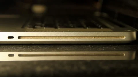 Hand Inserting DVD In Laptop, Media, Technology, Energy, Side Shot Video stock 42849119