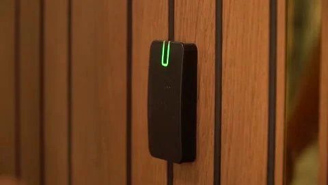 A hand inserting keycard in the electronic lock Stock Footage 156027597