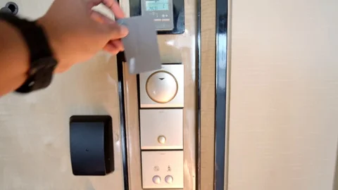 Hand inserting a keycard to unlock door Stock Footage 91864307