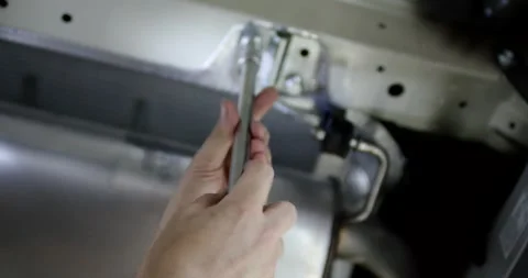 Hand Inserting a Metal Pin into a Perforated Plate in a Workshop Stock-Footage 340282635