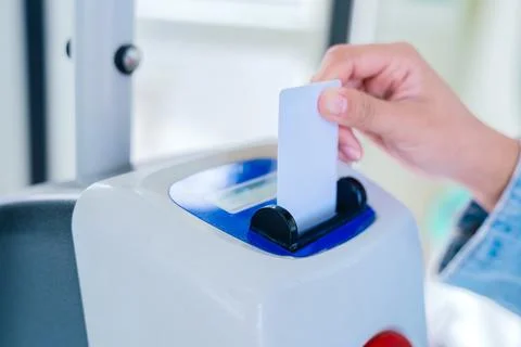 Hand Inserting Ticket Into Validation Machine on Public Transport Stock Photos