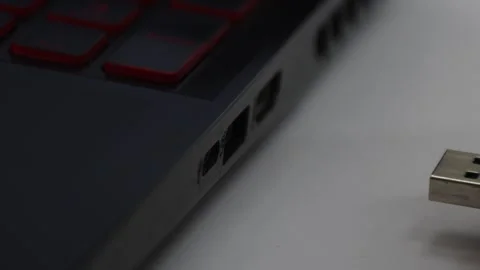 Hand inserting a USB cable into a laptop, connecting peripherals to computer Stock Footage 305779492