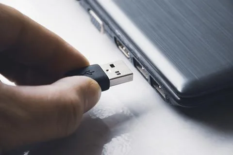 Hand inserting USB connecting to usb port  Stock Photos