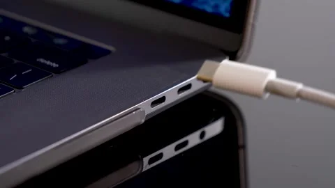 Hand inserting USB Type C wire into laptop computer. Fast Charging Type Stock Footage 150557080
