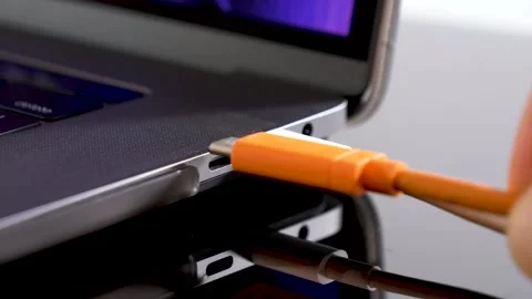 Hand inserting USB Type C wire into laptop computer. Fast Charging Type Stock-Footage 150557095