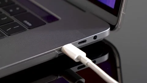 Hand inserting USB Type C wire into laptop computer. Fast Charging Type Stock Footage 150557101