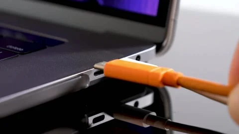 Hand inserting USB Type C wire into laptop computer. Fast Charging Type Video stock 150557277