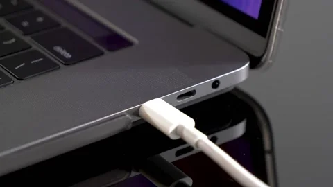 Hand inserting USB Type C wire into laptop computer. Fast Charging Type Stock Footage 150557288