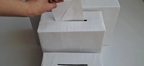 Hand Inserting White Envelope into Ballot Box - Election Concept 動画素材 332243096