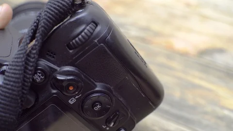 A hand inserts and removes SD memory cards into the camera. Stock Footage 119494759