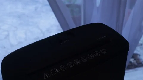 A hand inserts a document into a shredder Stock Footage 125434907