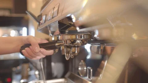 Hand inserts a handle with coffee in a coffee machine Stock Footage 117580460